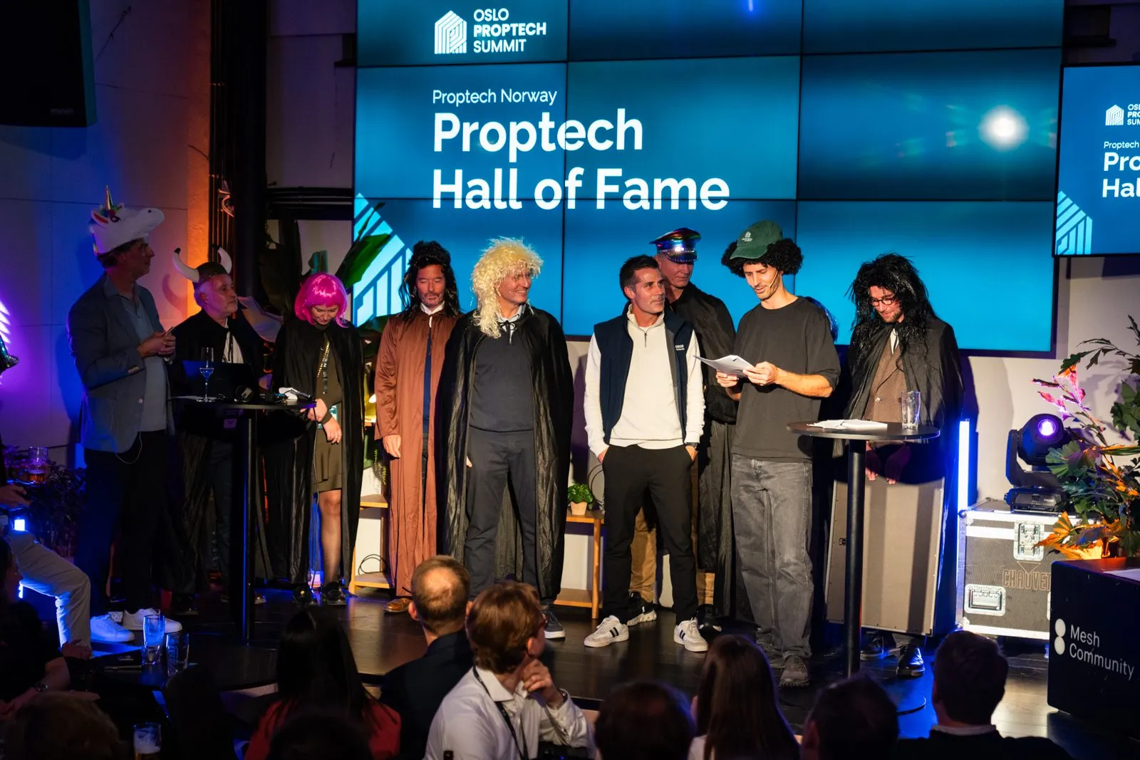 The Proptech Hall of Fame is called up, flanked by a stage crew in capes and wigs.